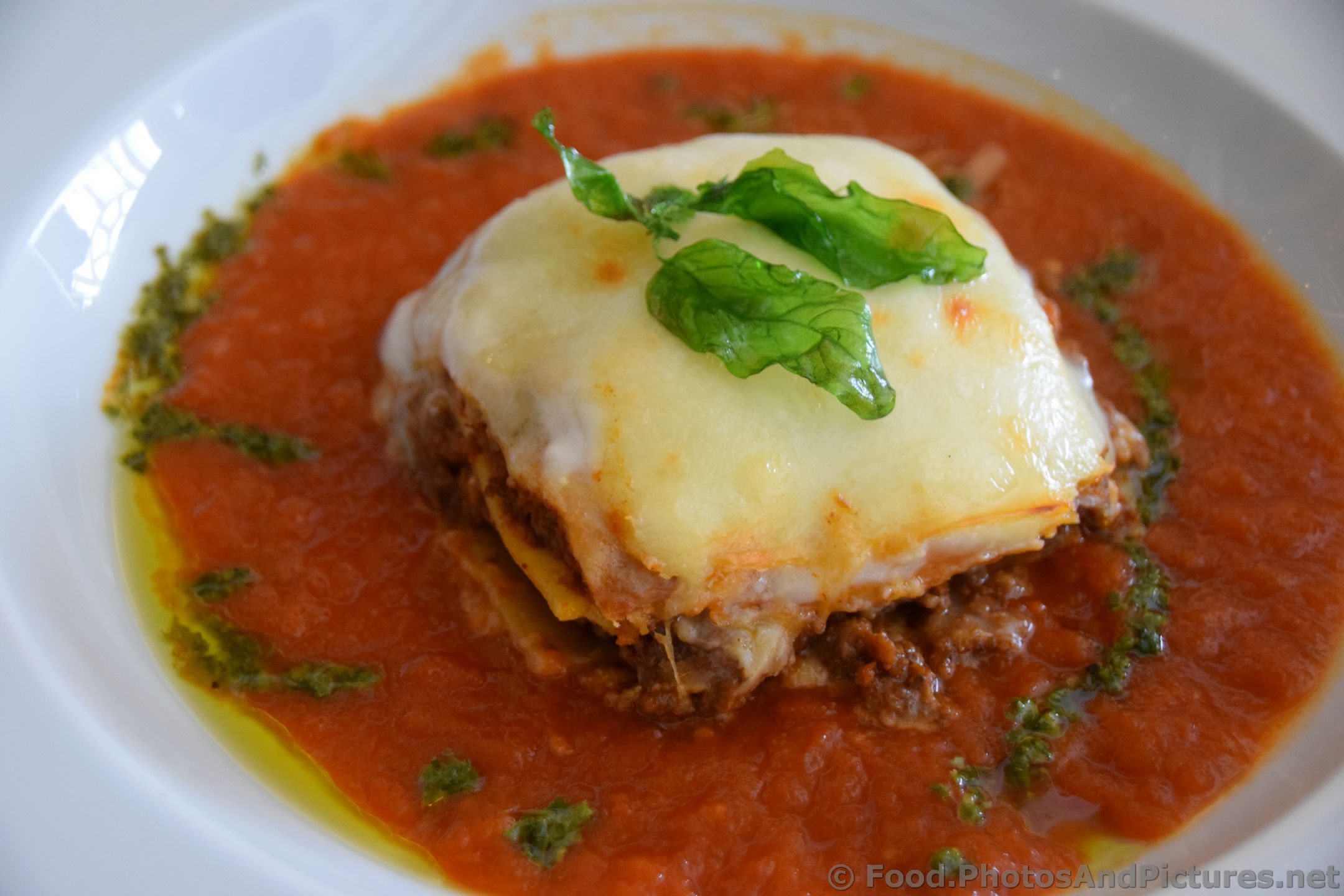 Meat Lasagna Topped with Fried Basil Leaves.jpg